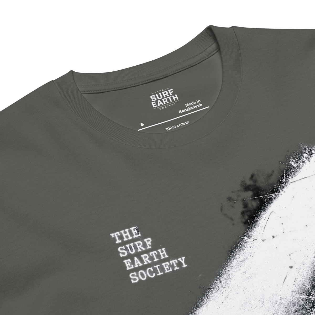 Close-up of a dark gray t-shirt with a white distressed graphic print on the front and inside collar. The brand 'Surf Earth Society' is printed in white on the chest and inside the collar.
