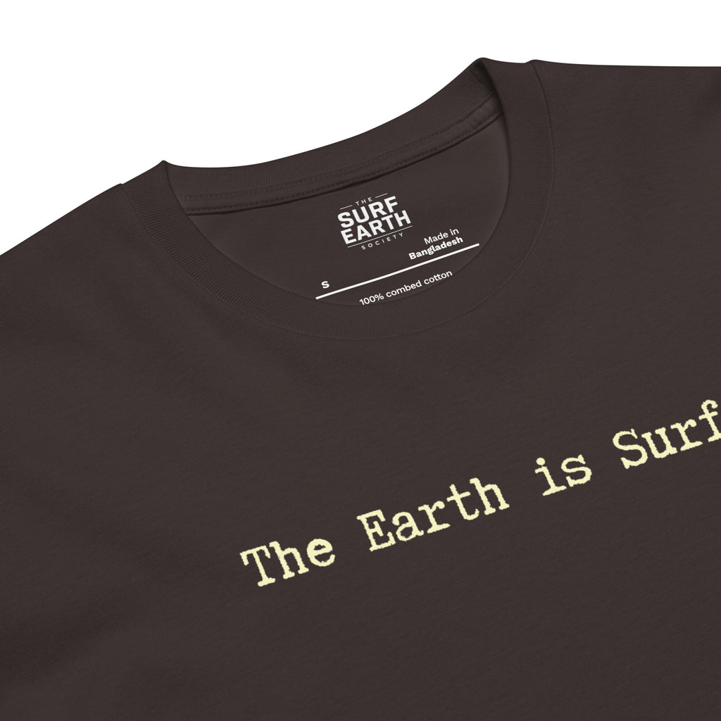 Close-up of a coal color t-shirt with the phrase 'The Earth is Surf."