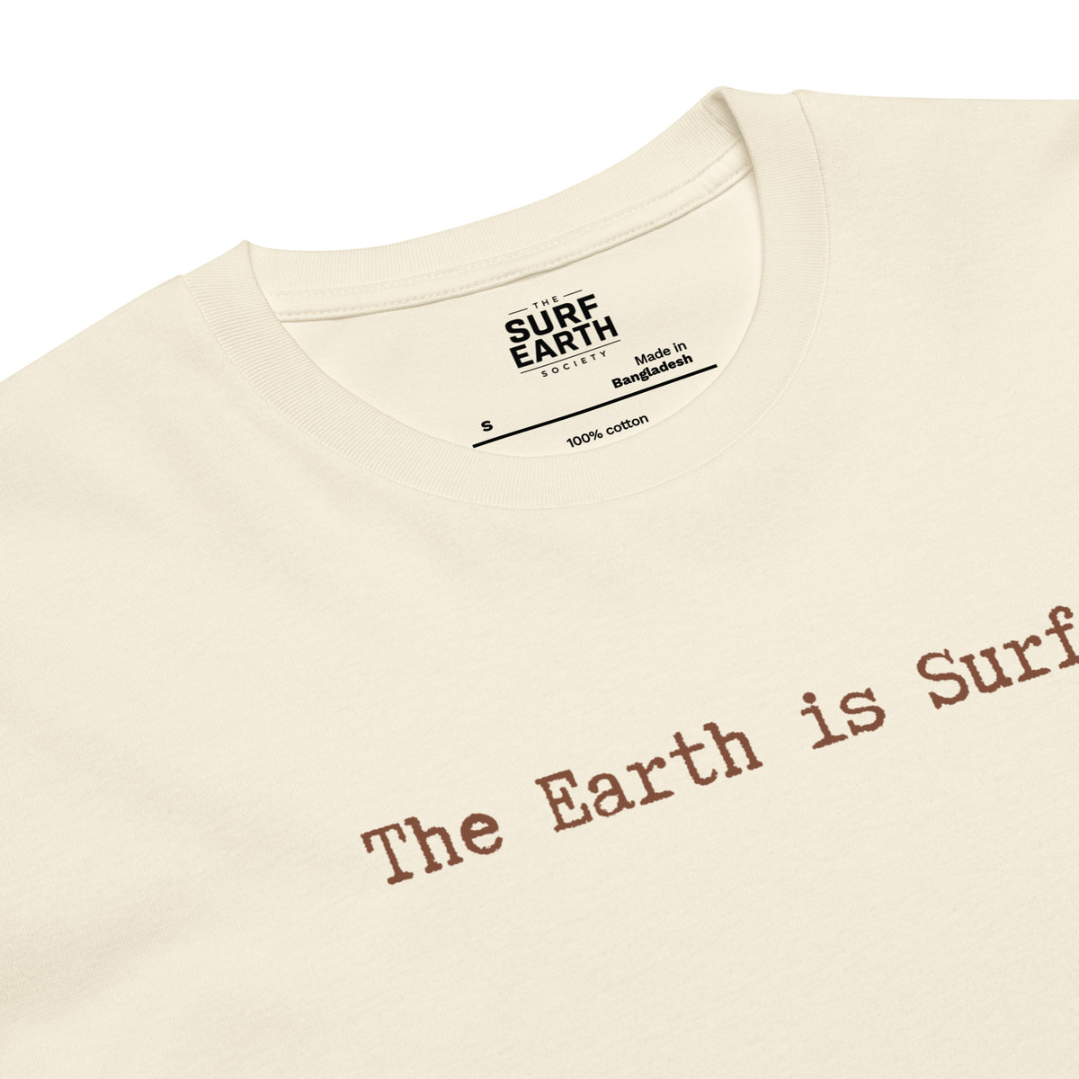 Close-up of a beige natural color t-shirt with the phrase 'The Earth is Surf."