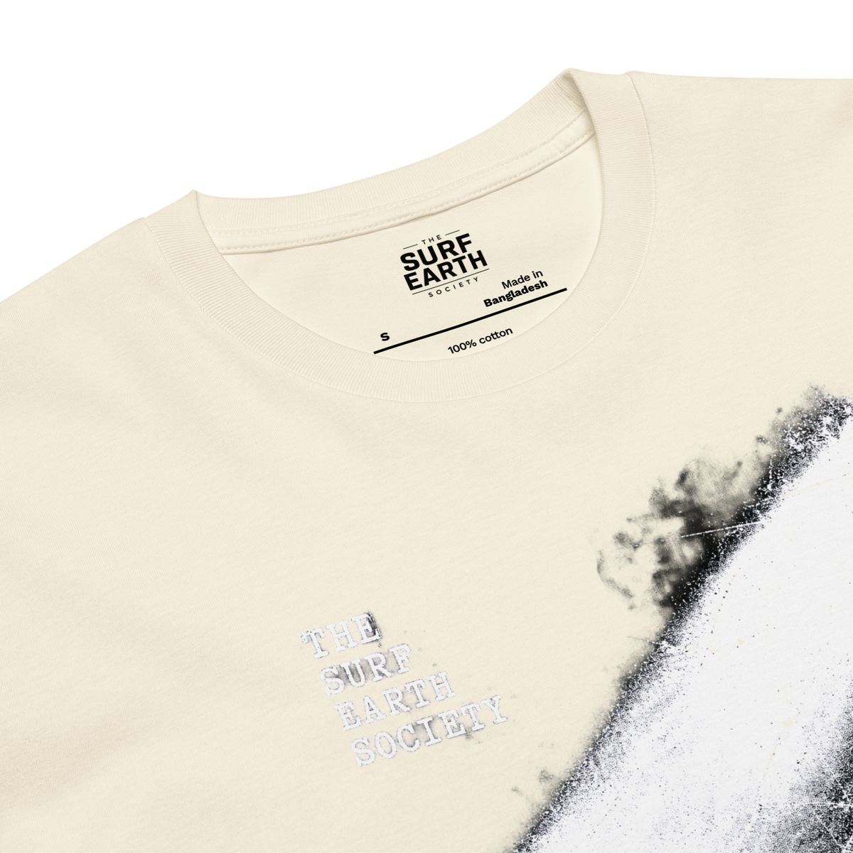 Closeup natural beige 100% cotton Vintage surf T-shirt featuring a longboard surfer entering the ocean under a dramatic light